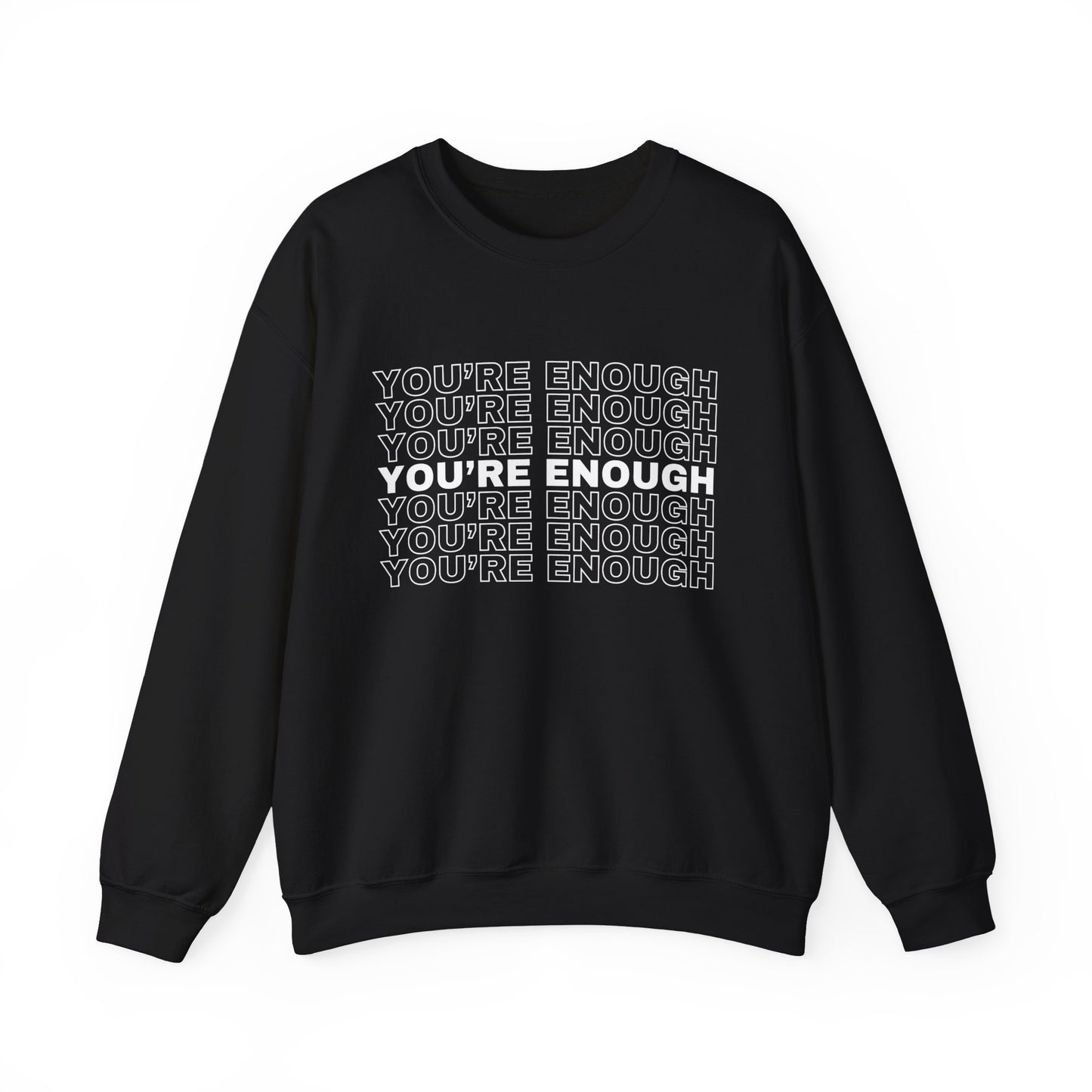 A woman sitting on a bed, embodying empowerment in the You're Enough Unisex Heavy Blend Crewneck Sweatshirt.