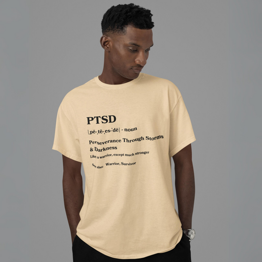 Man in a beige PTSD Definition Unisex Jersey Short Sleeve Tee with an inspirational quote about mental health awareness, presenting an acronym that stands for "perseverance through storms & darkness.